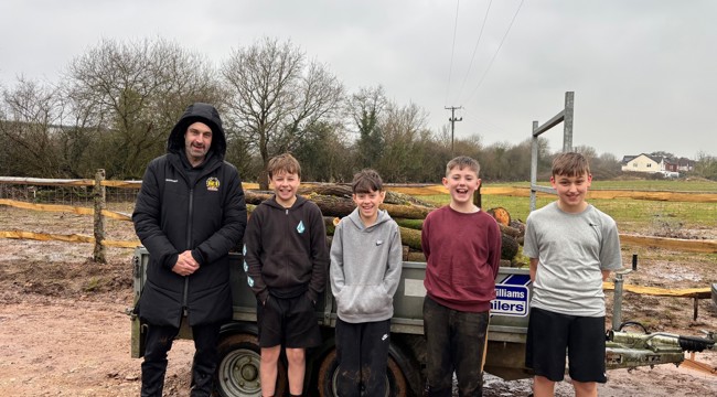 Exeter Chiefs Representative and four young boys standing in front of a trailer